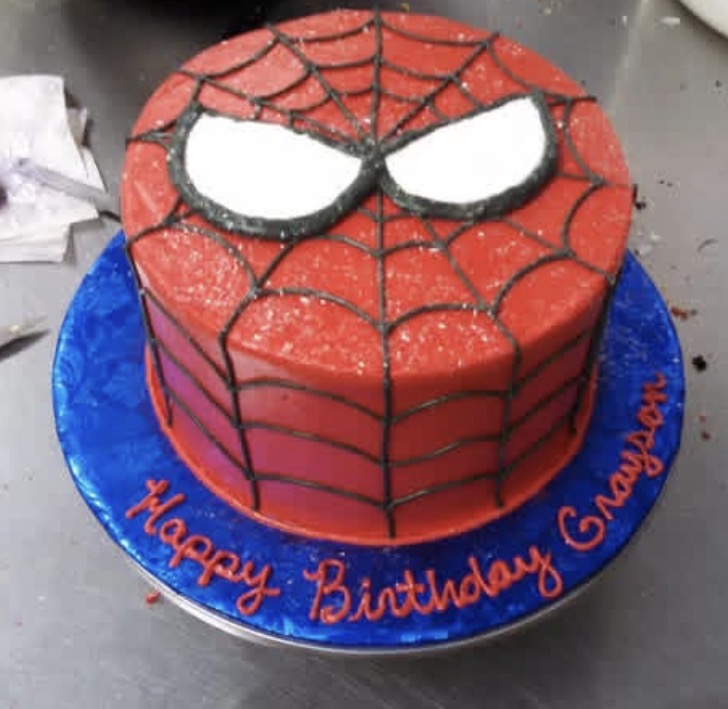 Spider-web themed birthday cake in red and blue buttercream