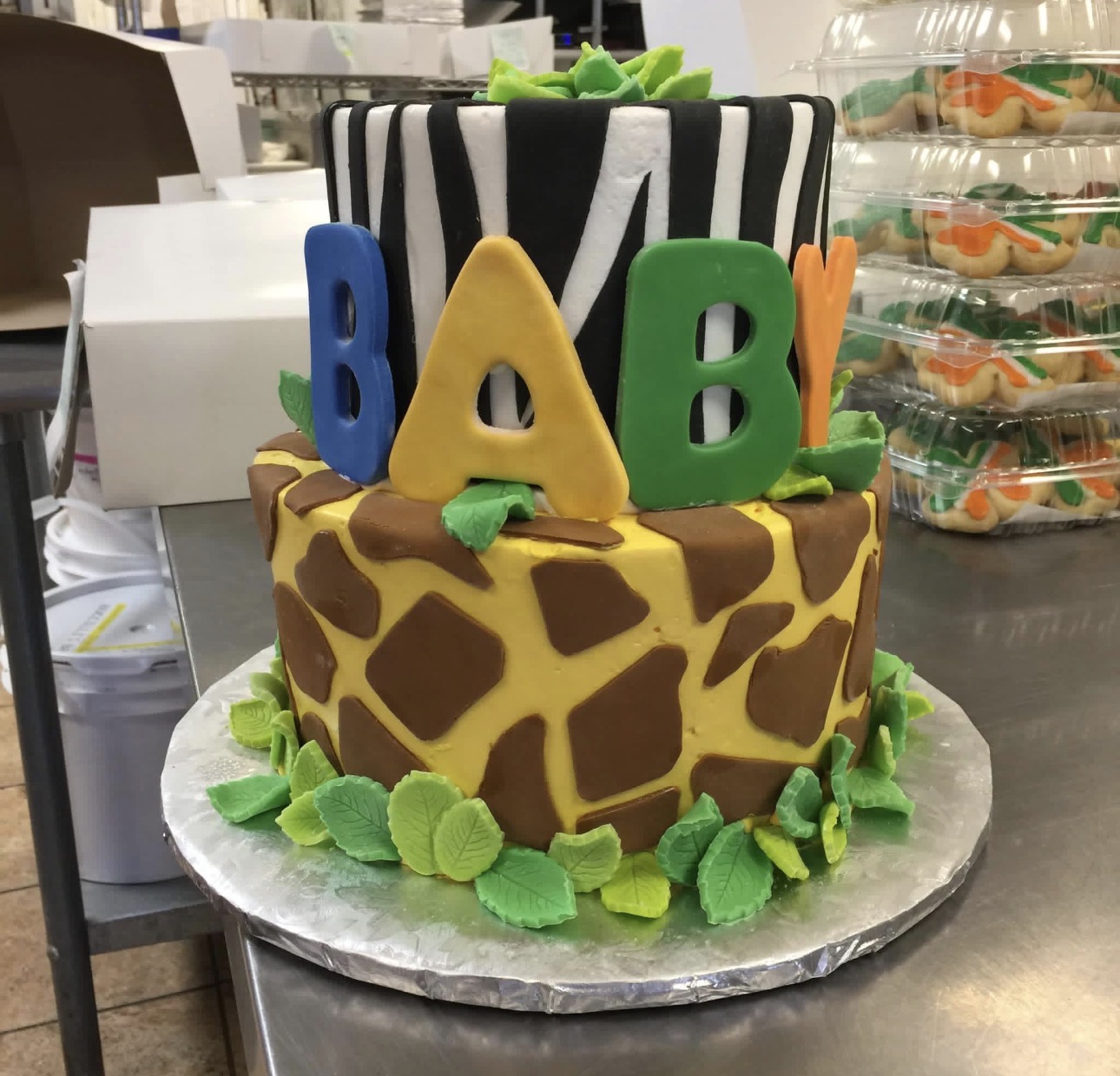 Two-tier baby shower cake with zebra and giraffe print fondant and BABY letters