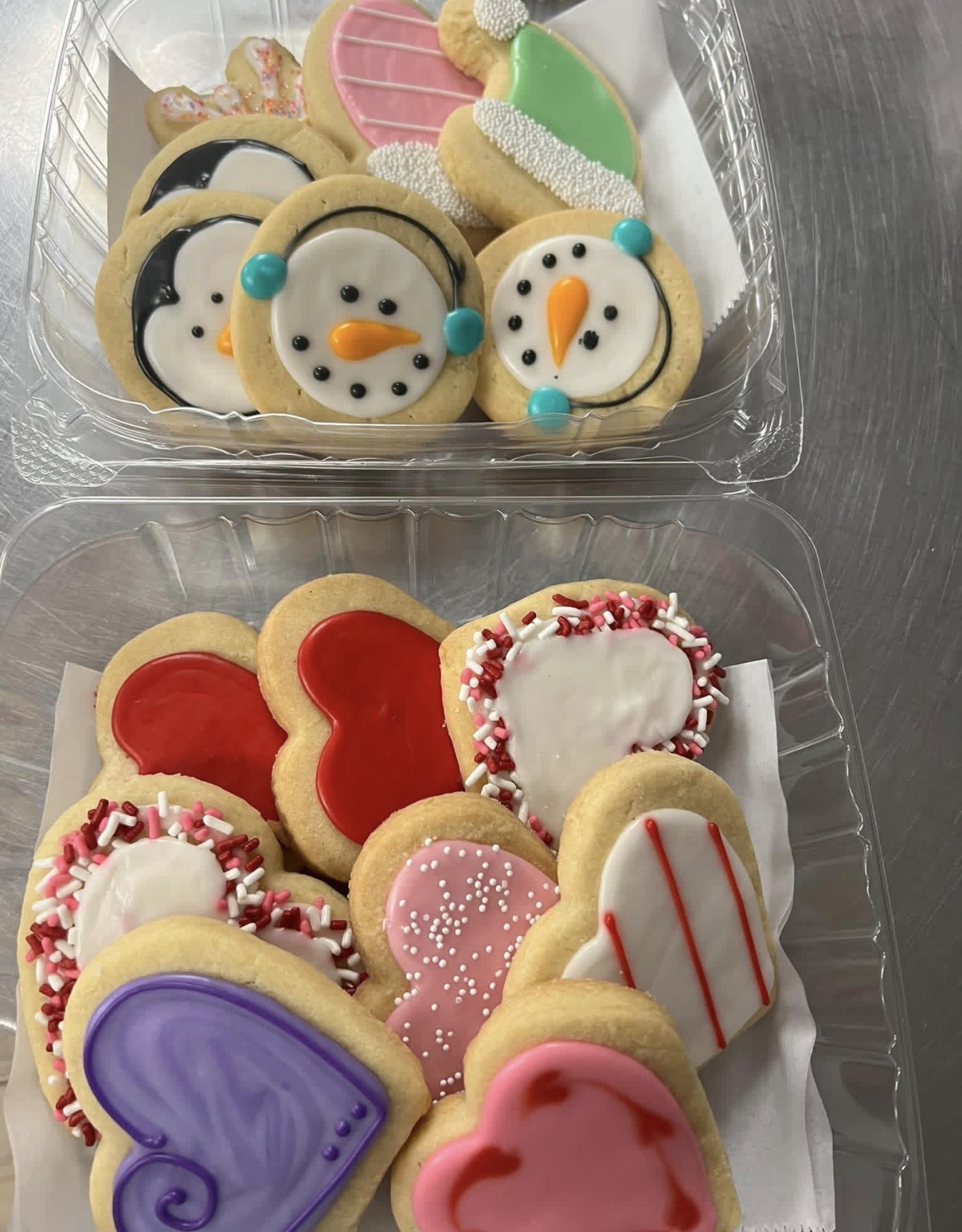 Snowman and mitten cookies plus red, pink and purple Valentine heart sugar cookies