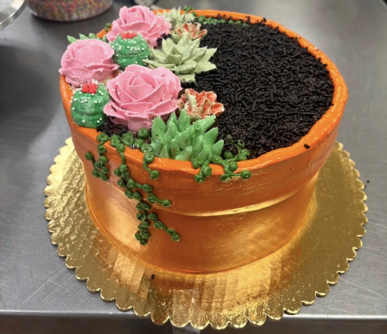 Flower pot cake with buttercream roses, succulents and cookie-crumb soil
