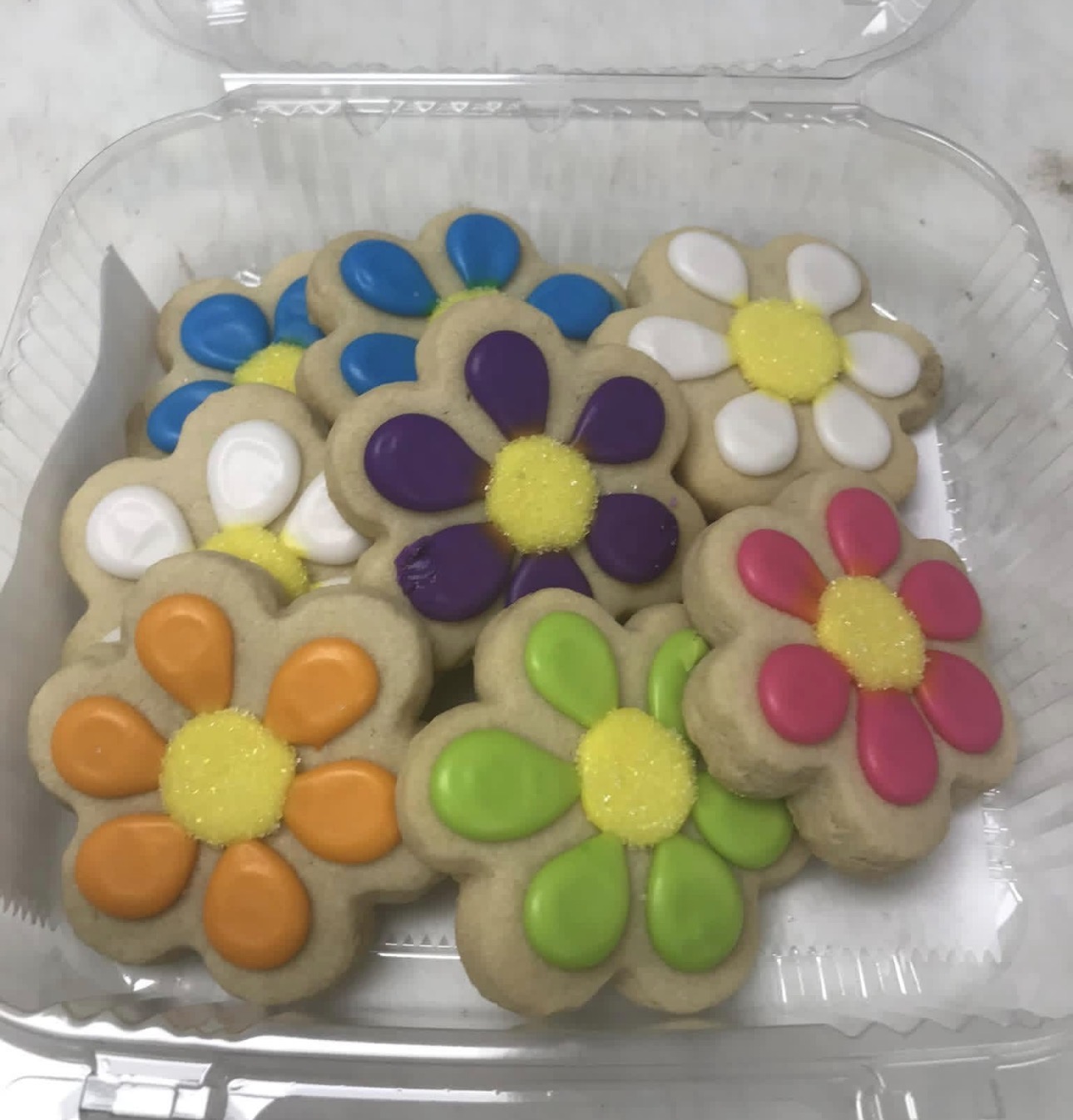 Box of bright flower sugar cookies in orange, purple, blue, green, pink and white