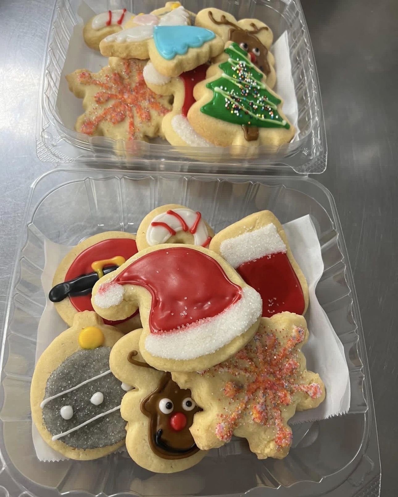 Holiday cookie boxes with santa hats, stockings, snowflakes, reindeer and ornaments